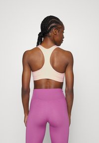 Nike Performance BRA - Sutiã desportivo de suporte médio - atmosphere/white