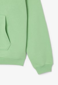 Felpa verde chiaro con tasca a marsupio, polsini e orlo a coste. Texture morbida, design informale e vestibilità leggermente oversize.
