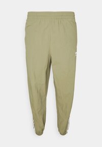 Ljus olivgröna träningbyxor med elastisk midja och mudd, vit Adidas-logotyp och tre ränder på underbenen.