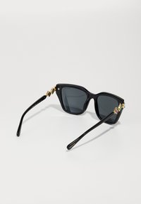 Swarovski Saulesbrilles - black