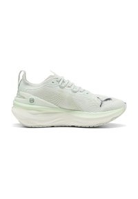 Sneaker sportivo bianco con tomaia in maglia testurizzata, suola spessa e imbottita, chiusura con lacci e un piccolo logo Puma nero nella zona delle dita.