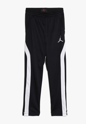 Pantalons de sport noirs avec une bande latérale blanche contrastante, taille élastique et logo Jumpman sur la cuisse gauche. Tissu doux et lisse.