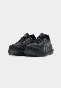 Black athletic shoes featuring a breathable mesh upper, textured panels, and a cushioned sole. Subtle reflective accents enhance visibility.