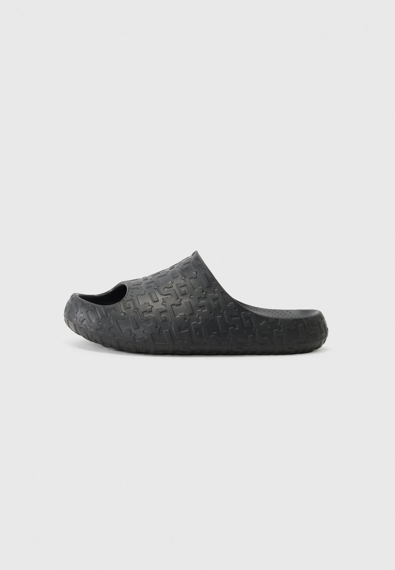 Infradito in gomma nera con tomaia perforata e superficie testurizzata caratterizzata da un motivo geometrico. Design aperto e forma sagomata per il comfort.