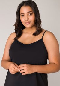 Zwarte mouwloze camisole met dunne bandjes, met een gladde textuur en een ontspannen pasvorm die soepel valt.