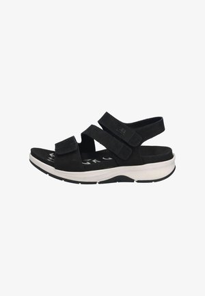 Black sandal with adjustable Velcro straps, cushioned footbed, and a white sole featuring a textured pattern for traction.