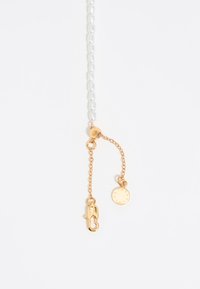 Gold-tone necklace with a clasp, featuring a chain with round, white beads and a small circular pendant displaying numerals.