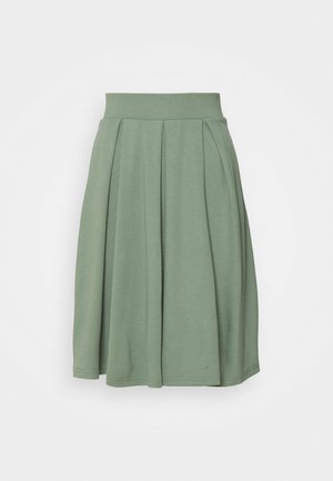 Pleated skirt in soft, stretchy green fabric with a wide waistband. Features a flowing silhouette and hemline that falls above the knee.