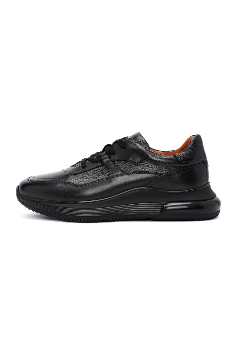 Sneaker in pelle nera con tomaia texturizzata, punta liscia e suola in gomma. Presenta lacci, colletto imbottito e un design slanciato e modellato.