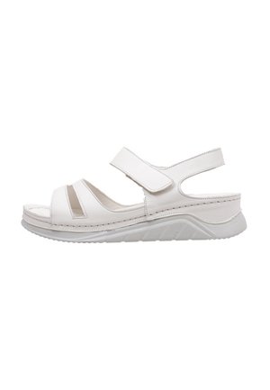 Sandale blanche avec de larges sangles Velcro, design à bout ouvert, semelle intérieure moulée et semelle en caoutchouc texturée. Comprend des découpes sur les côtés.