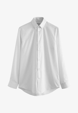 Camicia bianca a maniche lunghe realizzata in tessuto morbido, con colletto classico, chiusura a bottoni e orlo curvo. Nessun motivo o dettaglio visibile.