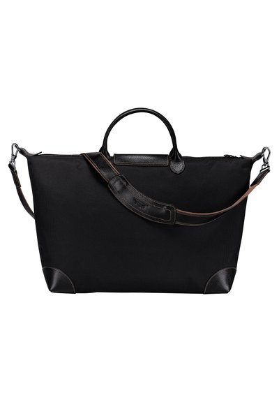 Große schwarze Reisetasche aus strukturiertem Stoff, mit Lederdetails, runden Griffen und einem verstellbaren Schultergurt.