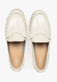 Cream-colored loafers made of glossy leather with a stitched design and a decorative cutout detail on the upper, featuring a smooth inner lining.