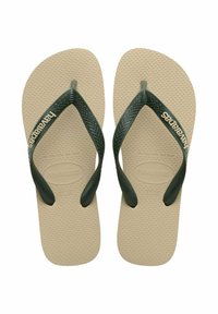 Chanclas de goma verdes con tiras texturizadas y una suela texturizada beige. Presentan la marca Havaianas en la tira. Talla 37-38.