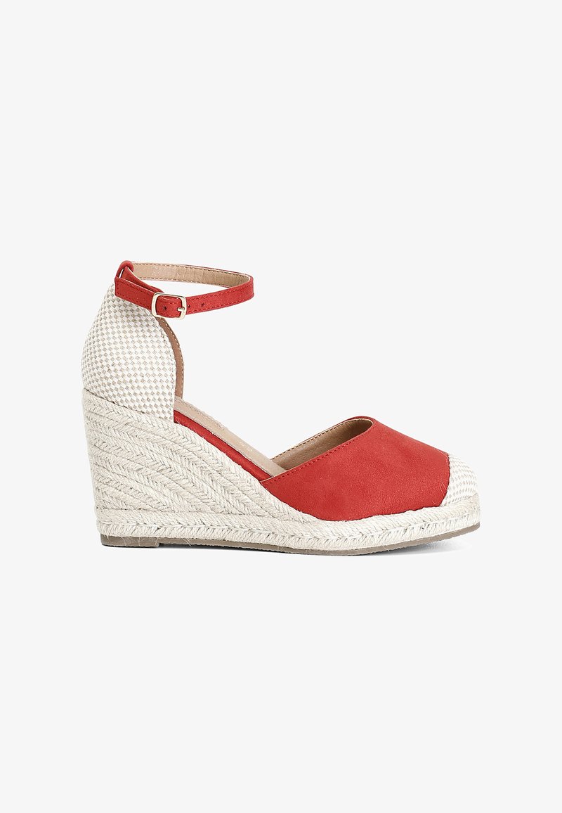 Red espadrille wedge shoe with a textured white fabric heel, adjustable ankle strap, and woven jute midsole. Seamless design and rounded toe.