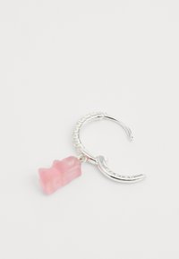 Sidabrinė auskarų žiedas su rausvu guminiu lokiu. Pakabukas turi blizgų paviršių, o žiedas yra tekstūruotas su "HARIBO" užrašu.
