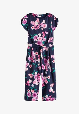 Combinaison bleu marine avec un imprimé floral vibrant rose et blanc, manches courtes, accents de boutons, et une taille nouée pour une silhouette définie.