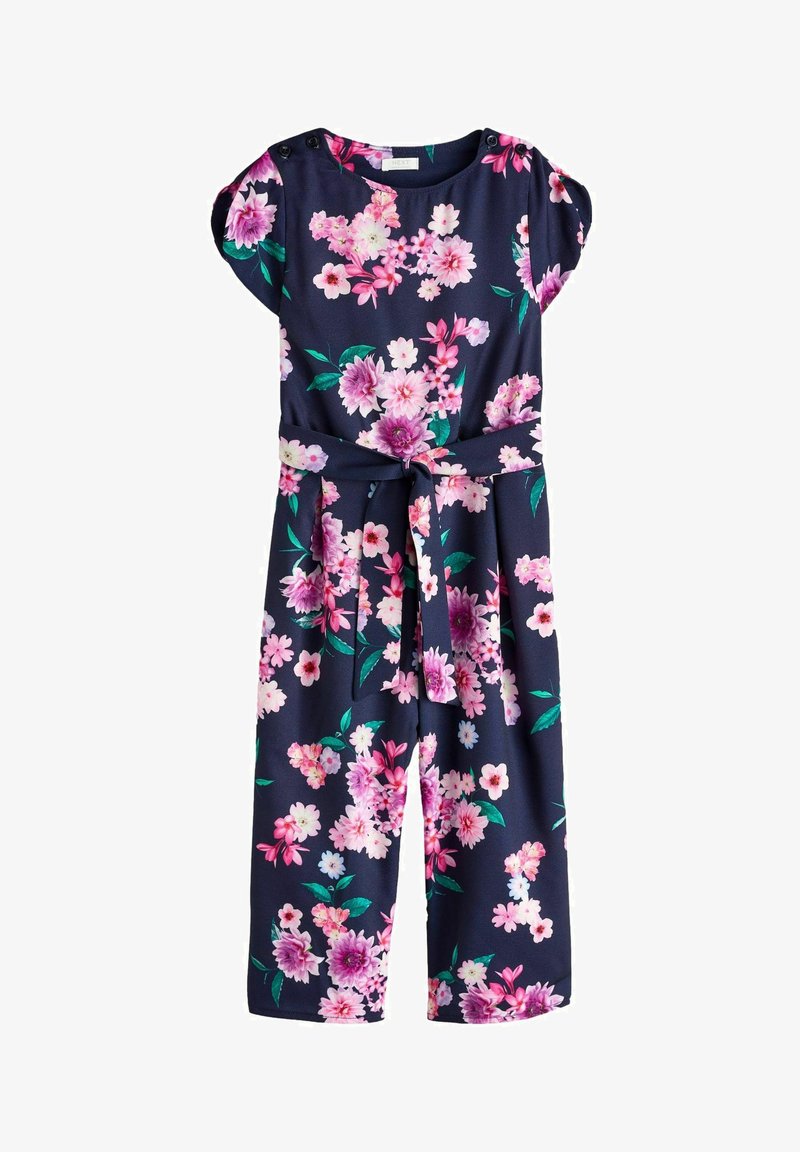 Combinaison bleu marine avec un imprimé floral vibrant rose et blanc, manches courtes, accents de boutons, et une taille nouée pour une silhouette définie.