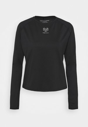 Haut noir à manches longues avec un col rond, fabriqué en tissu lisse. Présente un logo géométrique au niveau de la poitrine et des manches raglan.