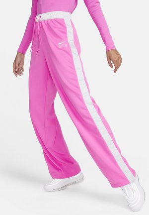 Pink athletic pants with white side stripes and an elastic waistband. Made of smooth fabric, featuring a logo on the left thigh.