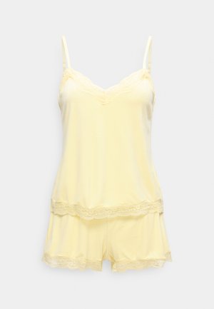 Weiches gelbes Camisole- und Shorts-Set mit Spitzenbesatz am Ausschnitt, Saum und den Shorts, auf einfarbigem Hintergrund dargestellt.