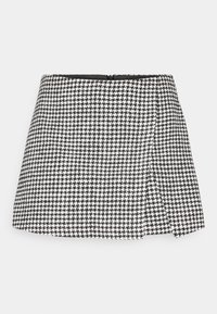Black and white houndstooth mini skirt with a straight cut, side zipper closure, and structured fabric. Plain black inner lining.