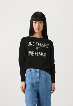 Maglione nero lavorato a maglia con testo grigio chiaro "UNE FEMME est UNE FEMME" sul davanti, con una vestibilità comoda e scollatura ampia.