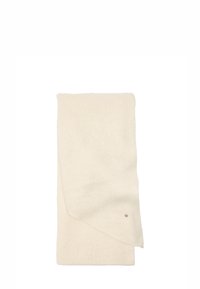 Jasno beżowy wełniany koc, miękka faktura, prostokątny kształt, z subtelnym połyskiem. Posiada złożony brzeg oraz mały metaliczny detal z logo.