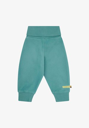Turquoise joggingbroek van zacht materiaal, met een brede tailleband en geribde boorden. Etiket hangt aan de linkerkant.