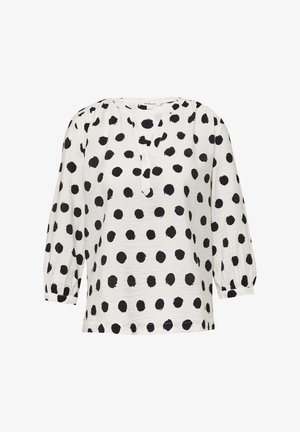 Weiße Bluse mit schwarzen Punkten, Rundhalsausschnitt und dreiviertellangen Puffärmeln. Leichter Stoff mit einer leicht strukturierten Oberfläche.