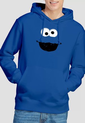 Blue hoodie made of cotton-blend fabric, featuring a large printed face with two eyes and a mouth in black, with a kangaroo pocket.