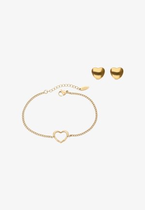 Sieradenset in goudkleur met een armband in de vorm van een hart met een kettinkje en bijpassende oorstekers in de vorm van een hart. Gladde afwerking, simpel en elegant.