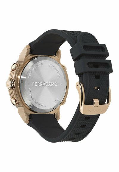 Ferragamo kell, millel on roostevabast terasest korpus, pronksaktsendid, safiirkristall ja must kummirihm, millel on tekstuuritud muster ja pandla.
