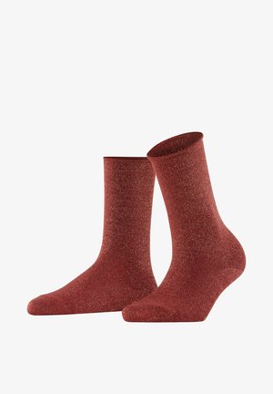 Red socks made of a textured material with a glittery sheen. Ankle height with a smooth top band and rounded toe design.