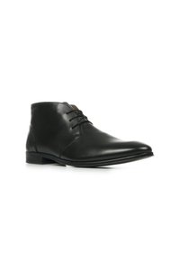 Bottines en cuir noir avec une finition lisse, dotées d'un bout rond, d'un design à lacets et d'une marque subtile sur le talon.