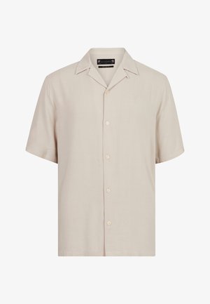 Kortærmet skjorte i lys beige stof med klassisk krave, seks knapper ned langs fronten og et diskret broderet logo på brystet.