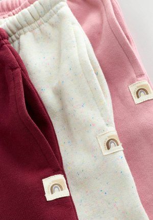 Pantaloni de jogging din bumbac în nuanțe de burgund, roz și crem, cu pete multicolore; prezintă broderii cu logo-uri în formă de curcubeu pe părți.