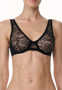 Zwarte kant bralette met een doorschijnend bloemenpatroon, driehoekige cups, brede banden en een stevige band. Ontworpen voor een aansluitende en comfortabele pasvorm.