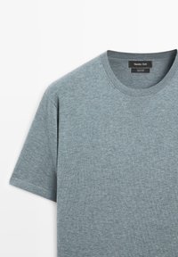 T-shirt en coton gris chiné à manches courtes avec col rond, montrant le devant supérieur et l'étiquette du col de la marque Massimo Dutti.