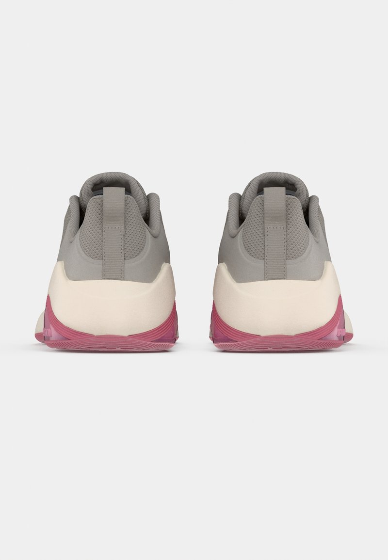 Gray athletic shoes with a smooth upper, textured panels, and a pink translucent sole. Features a back tab for easy wear.