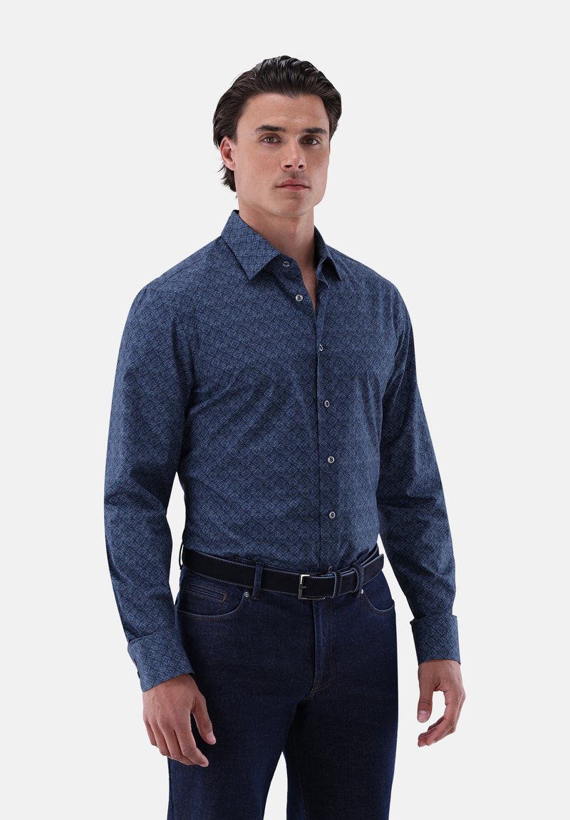 Blue patterned shirt with a button-up design, long sleeves, and a classic collar, paired with dark denim jeans and a black belt.