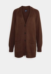 Hnědý pletený kardigan s výstřihem do V, dlouhými rukávy, šesti černými knoflíky a dvěma předními kapsami. Texturovaná látka a žebrované manžety.