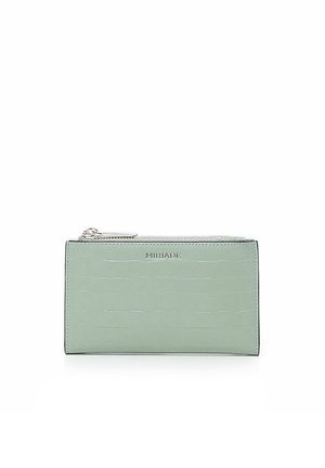 Portafoglio verde menta con texture coccodrillo, zip argentata e logo impresso. Forma rettangolare con linee pulite e una finitura liscia.