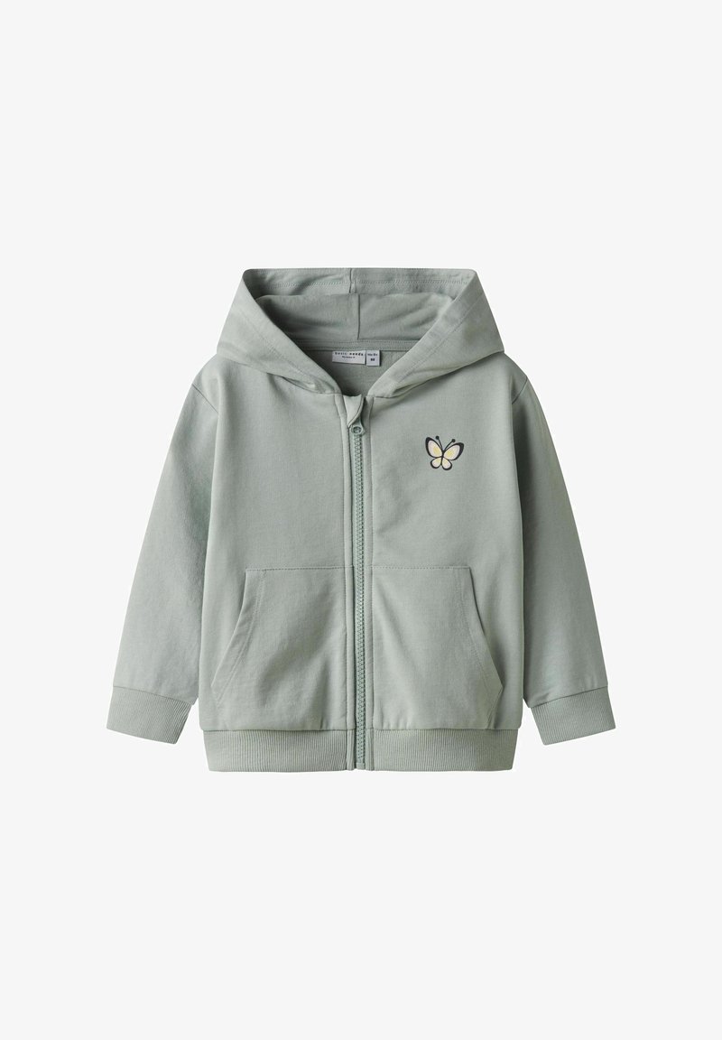 Haut de sweat à capuche zippé vert menthe en tissu doux, avec une poche avant et une broderie de papillon sur la poitrine gauche. Mélange de coton.