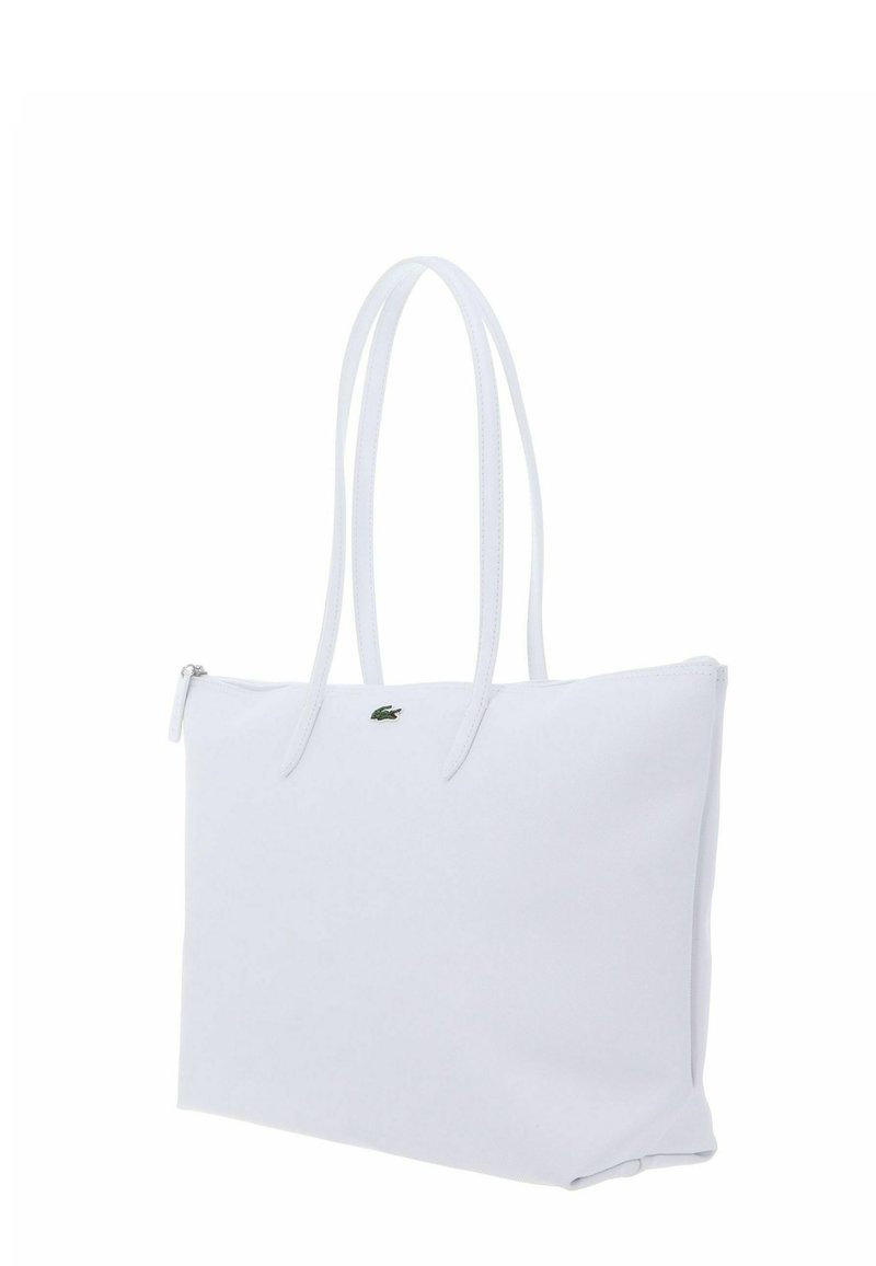 Borsa a mano rettangolare bianca con manici lunghi, chiusura con cerniera e un piccolo logo di coccodrillo verde al centro anteriore.