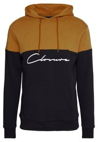 Felpa con cappuccio dal design a blocchi di colore, con una parte superiore dorata e una sezione inferiore nera. Logo bianco stampato sul davanti. Tasca a marsupio.