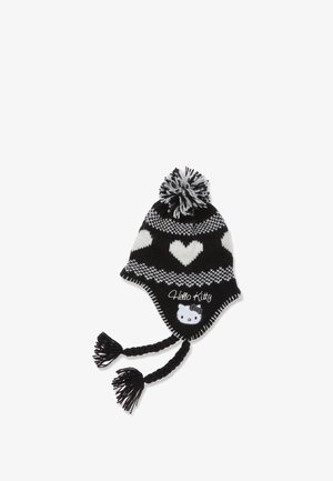 Zwart-witte gebreide muts met een hartpatroon, gevlochten banden en een pompon. Heeft een Hello Kitty ontwerp aan de voorkant.
