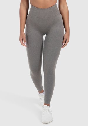 Leggings grigi alti in vita realizzati in tessuto elasticizzato con una texture liscia, dotati di una cintura ampia e una silhouette aderente.