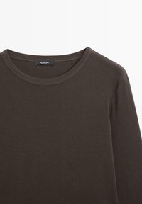 Dark brown long-sleeve T-shirt with a round neck. Made from a soft, smooth fabric. Features a subtle label at the neckline.