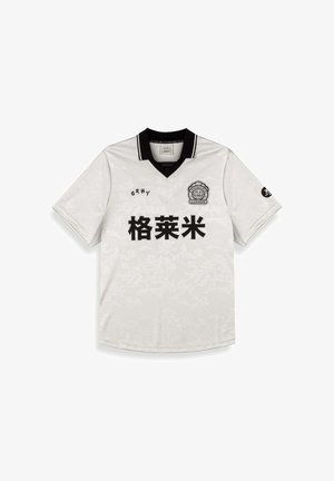 Korte mouwen witte jersey met een zwarte kraag. Bevat een subtiele bloemenstructuur en zwarte gedrukte tekst. Logo op de borst en mouw.